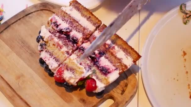 A gyerek felvágja a szülinapi tortáját egy nagy késsel. — Stock videók