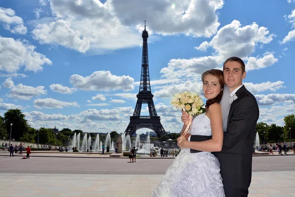 Beautiful wedding couple. Bride and groom in front of the Eiffel Tower in Paris.