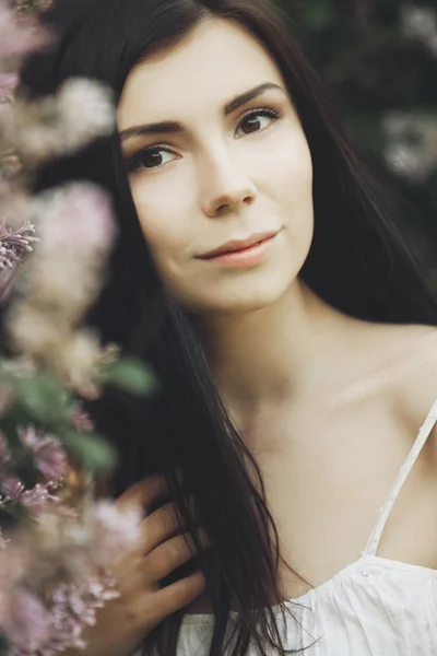 Rapariga em flores lilás — Fotografia de Stock