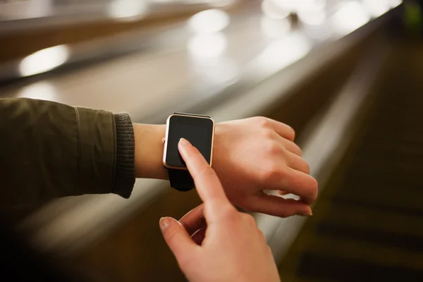 Woman using smart watch in metro — Stock Photo, Image