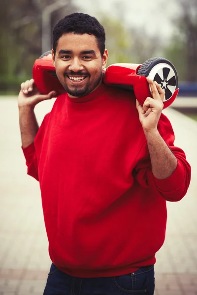 Young black boy with electric mini segway hover board scooter — Stock Photo, Image