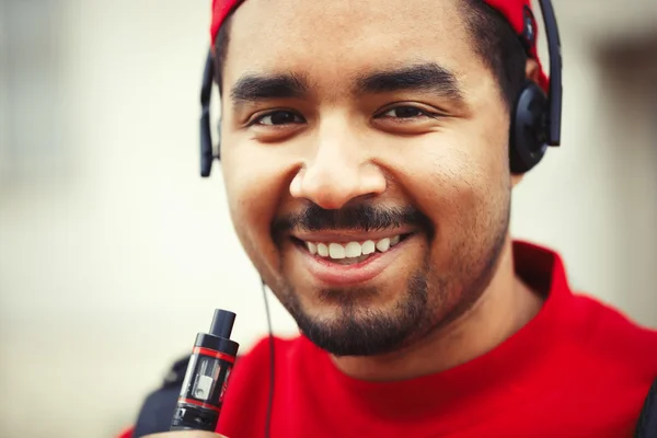 Young black man smoking e-cigarette vaporizer device — Stock Photo, Image