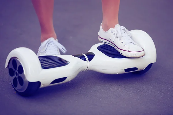 Pies de niña montando mini scooter eléctrico hoverboard — Foto de Stock