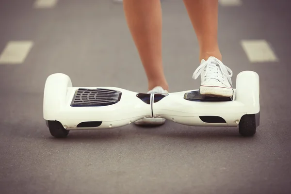 Feet of girl riding electric mini hoverboard scooter — Stock Photo, Image