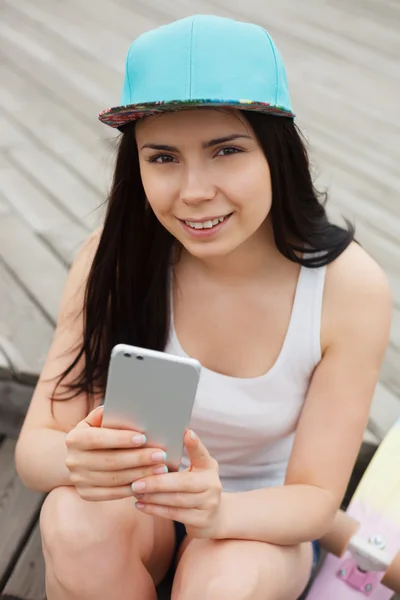 Girl using big modern phablet smartphone with dual camera — Stock Photo, Image