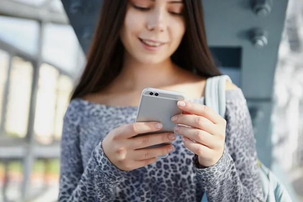 Cute white girl using modern dual camera smart phone — Stock Photo, Image