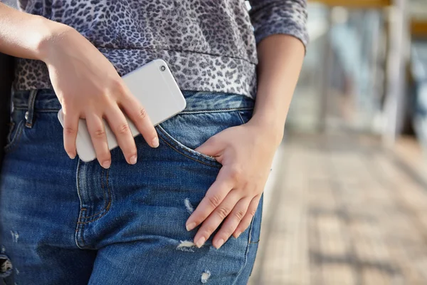 Woman holding modern smart phone in hand — 图库照片