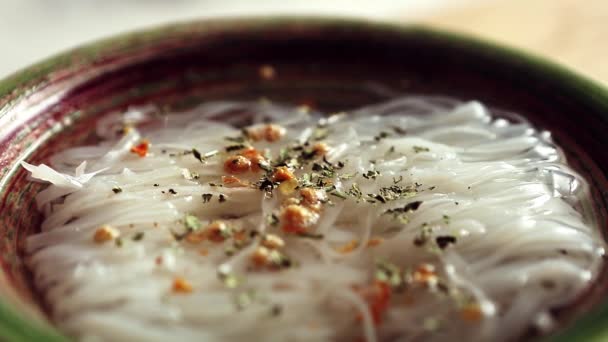 セラミックボウルで調理されたスパイス ハーブでアジアの麺スープ 東洋のカフェで朝食の食事のためのチキンスープで調製おいしい麺 アジアの伝統的なスパイシーな料理 — ストック動画