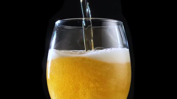 ビールグラスのスローモーションビデオクリップには 爽やかなラガー飲料が閉じ込められています バーでビール醸造所からのスローモ映像で高いピントガラスを充填白い泡と黄金のビール アルコール飲料 — ストック動画
