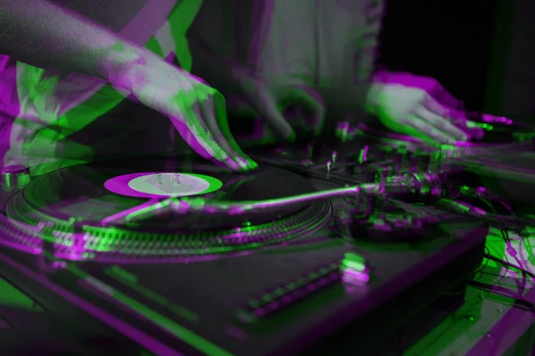 Party dj scratches vinyl records with hip hop music on vintage turn table player.Illustration edited with 3d stereo effect.Hands of concert disc jockey scratching record on retro turntables