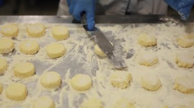 Mutfak çalışanı restoranda taze süzme peynirli cheesecake pişiriyor. Geleneksel Slav tatlı hazırlama