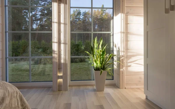 Яркий интерьер комнаты в деревянном доме с большим окном с видом на осенний двор. Дом и сад, осенняя концепция. — стоковое фото