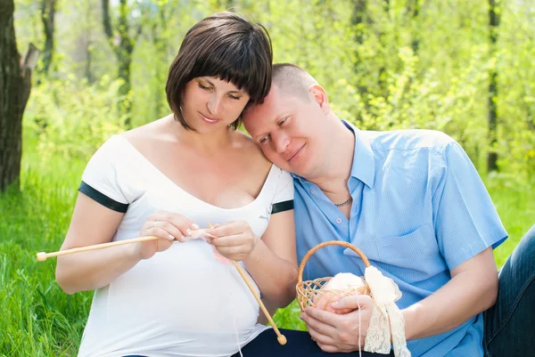 Happy Family in the Paek. Pregnant Woman knitting Stock Picture