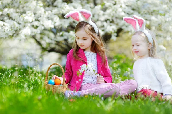 Hermanas pequeñas cazando huevos de Pascua — Foto de Stock