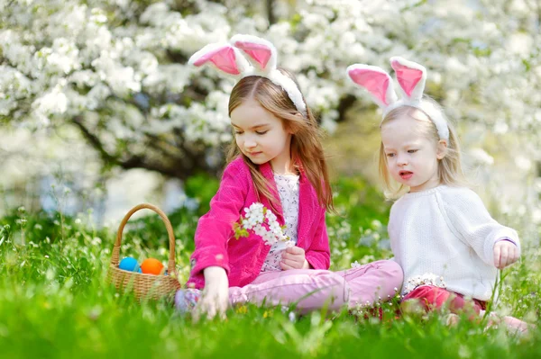 Hermanas pequeñas cazando huevos de Pascua — Foto de Stock