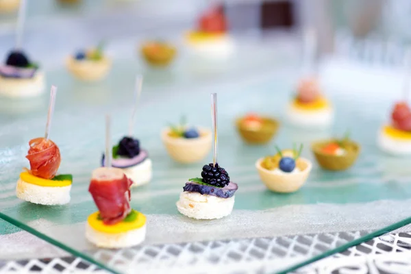 Plates with assorted finger food snacks — Stock Photo, Image