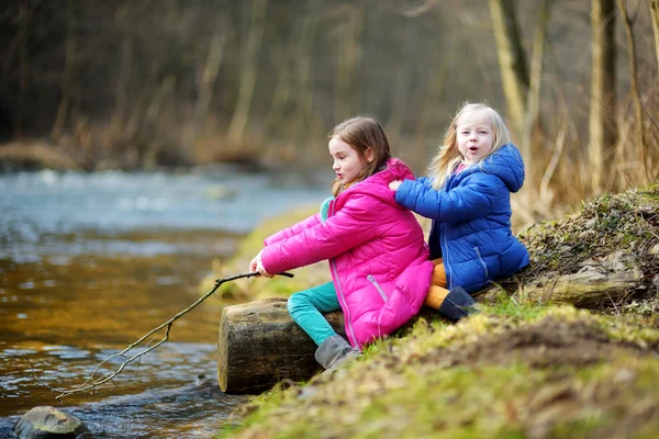 Zusters plezier door een rivier — Stockfoto