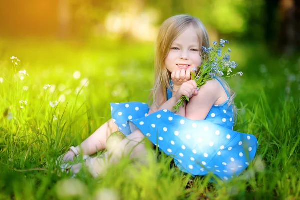 Little girl in blooming meadow — Stock Photo, Image