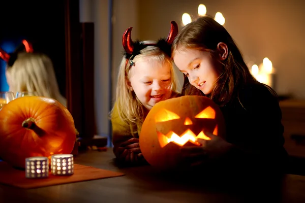 Two young sisters in halloween costumes