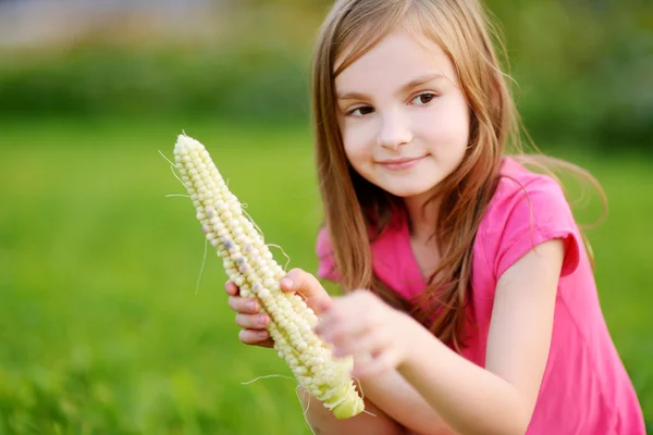 Bonita niña sosteniendo un maíz — Foto de Stock