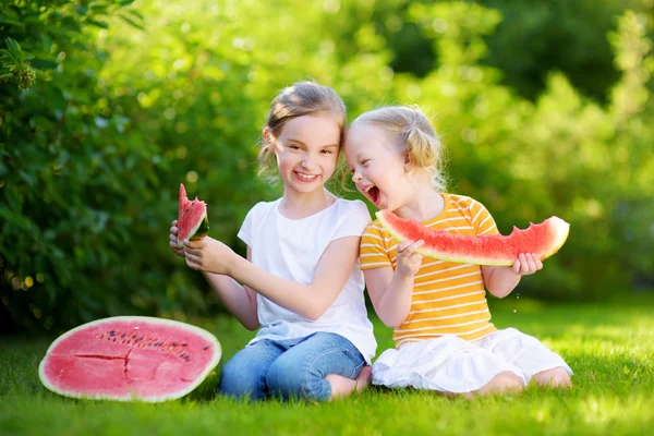 Little sisters eating watermelon — Stock Photo, Image