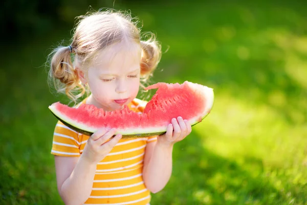Little girl biting watermelon — Stock Photo, Image