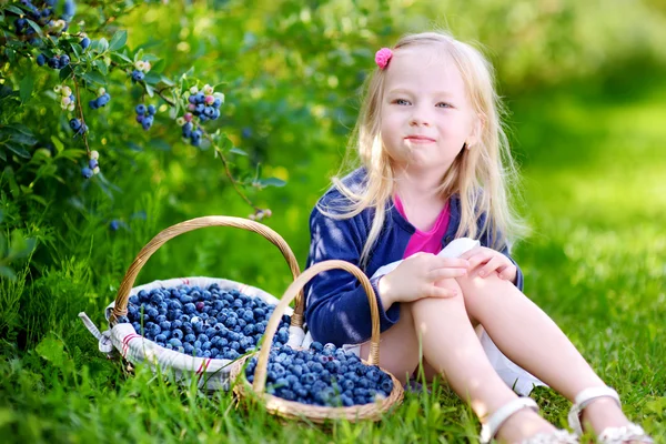 Girl with baskets of fresh berries — Stock Photo, Image