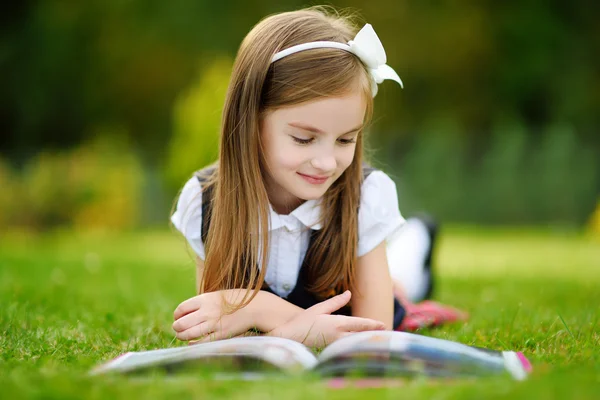 Adorable little girl reading book — Stock Photo, Image