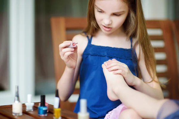 Adorable little girls painting nails — Stock Photo, Image