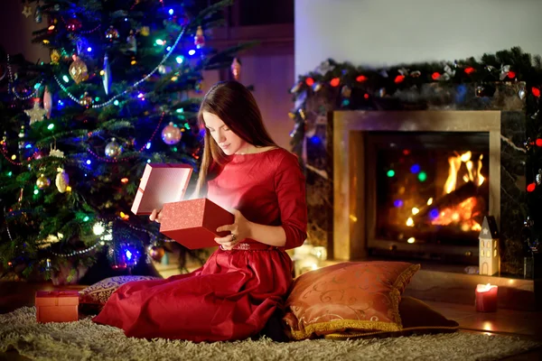 Woman opening magical Christmas gift — Stock Photo, Image