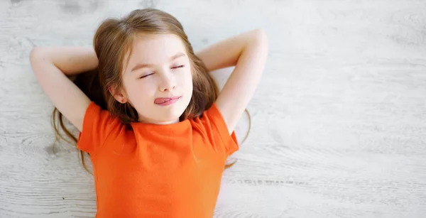 Little girl lying on  floor — Stock Photo, Image