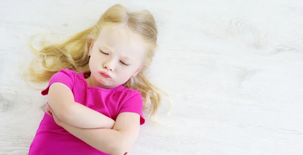 Little girl lying on  floor — Stock Photo, Image