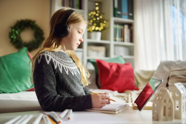 Young Schoolgirl Doing Her Homework Digital Tablet Christmas Time Child — Stock Photo, Image