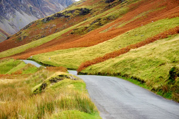 Honister Pass, a mountain pass with a narrow road winding along Gatesgarthdale Beck mountain stream. One of the steepest and highest passes in the region. Cumbria, the Lake District, England.