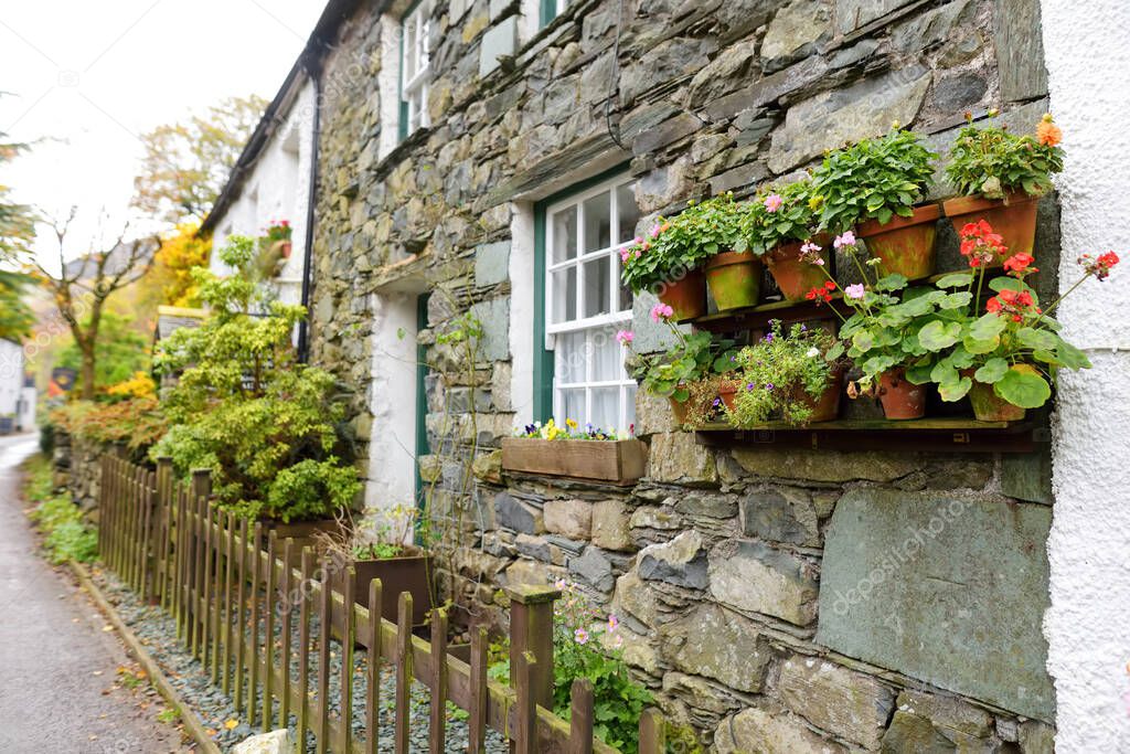 Houses of Stonethwaite village, beautifully decorated with flowers and greenery. Small village situated in the valley of the Stonethwaite Beck. Exploring beautiful nature of Cumbria, England.