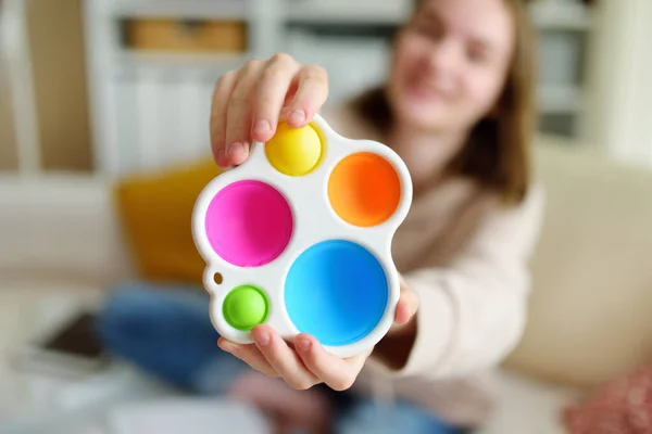 Teenage Girl Playing Rainbow Pop Fidget Toy While Studying Home — Stock Photo, Image