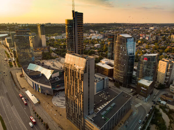 VILNIUS, LITHUANIA - OCTOBER 2019: Beautiful aerial evening view of Vilnius business district with scenic sunset illumination. City life in Vilnius, Lithuania.