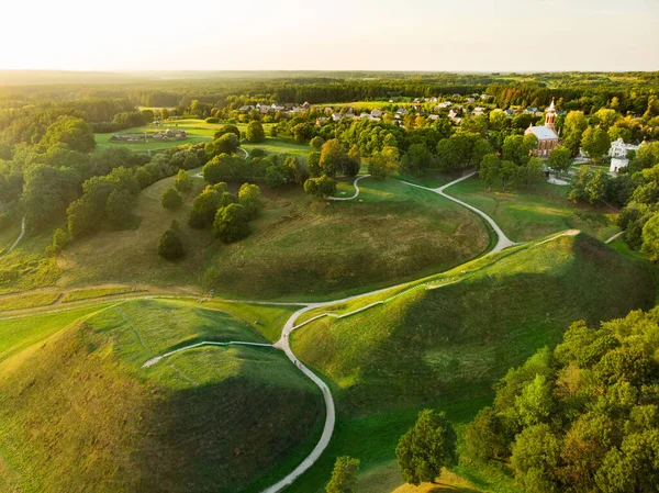 Aerial view of Kernave Archaeological site, a medieval capital of the Grand Duchy of Lithuania, tourist attraction and UNESCO World Heritage Site. Sunny summer evening.