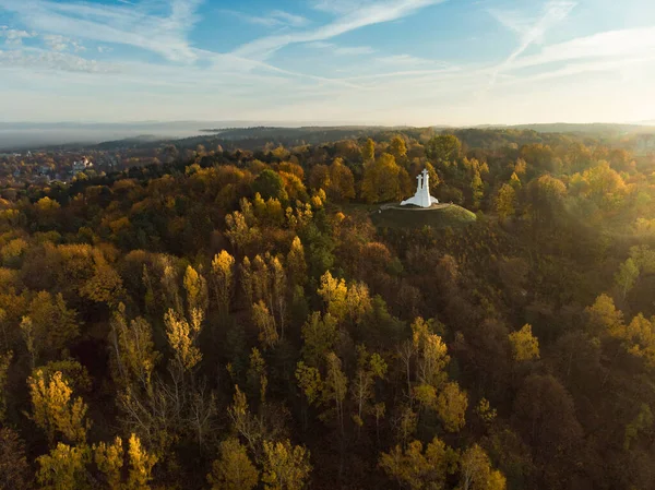 Aerial view of the Three Crosses monument overlooking Vilnius Old Town on sunset. Vilnius landscape from the Hill of Three Crosses, located in Kalnai Park, Lithuania