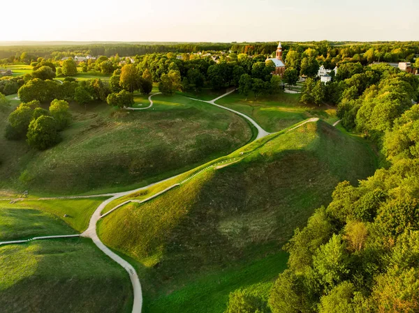 Aerial view of Kernave Archaeological site, a medieval capital of the Grand Duchy of Lithuania, tourist attraction and UNESCO World Heritage Site. Sunny summer evening.