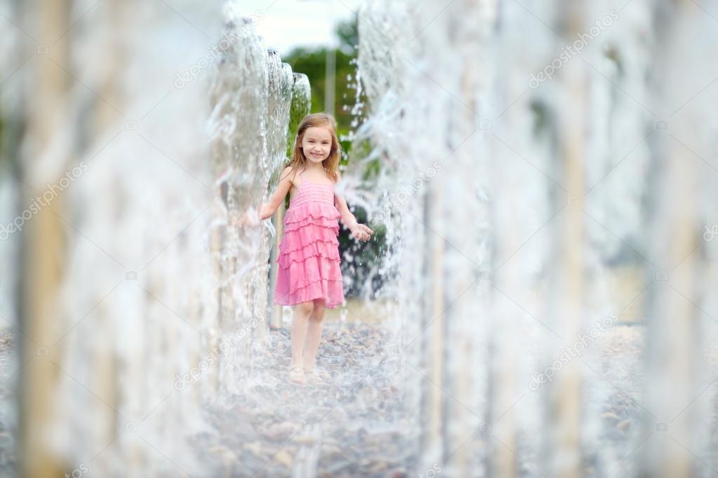 Girl playing with fountain