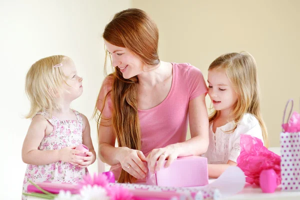 Mother and daughters with gift Stock Photo