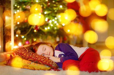 Noel ağacının altında uyuyan kız