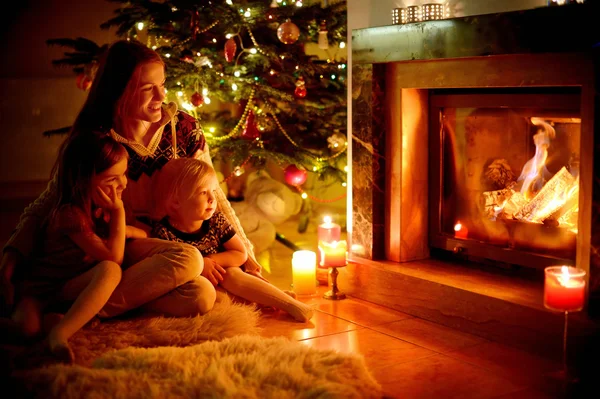 Mother and daughters near fireplace — Stock Photo, Image