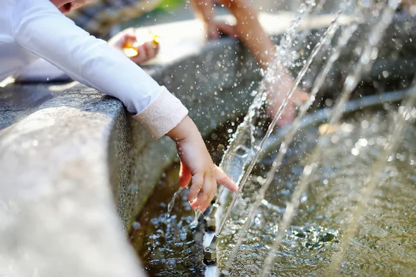 Niño lavándose las manos en la fuente — Foto de Stock