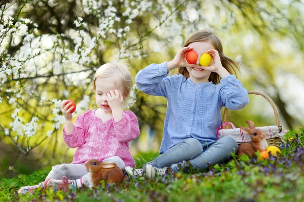 Little sisters playing with Easter eggs — Stock Photo, Image