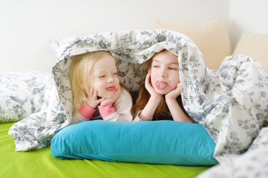 Sisters playing in bed clipart