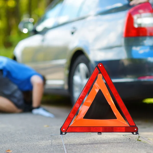 Red warning triangle sign on road — Stock Photo, Image