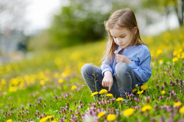 Chica en flor flores de diente de león — Foto de Stock