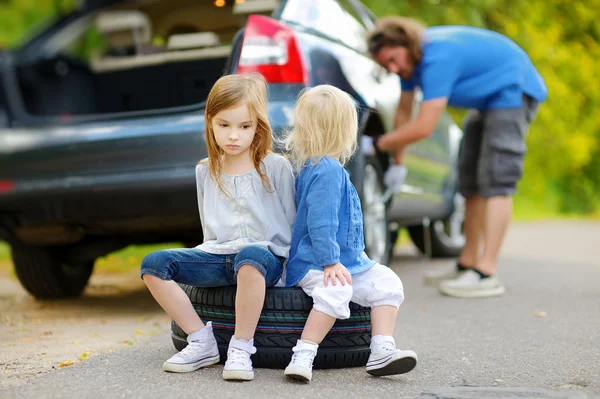 Little sisters sitting on tire — Stock Photo, Image